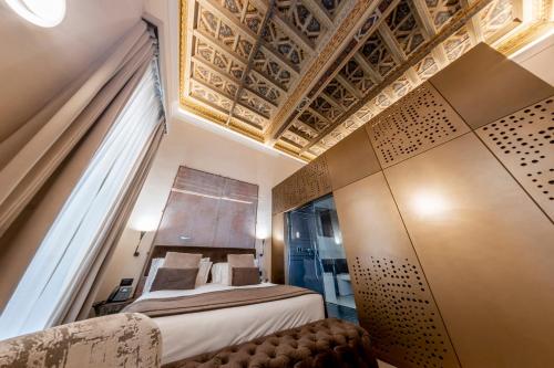 a hotel room with a bed and a window at Martius Private Suites Hotel in Rome