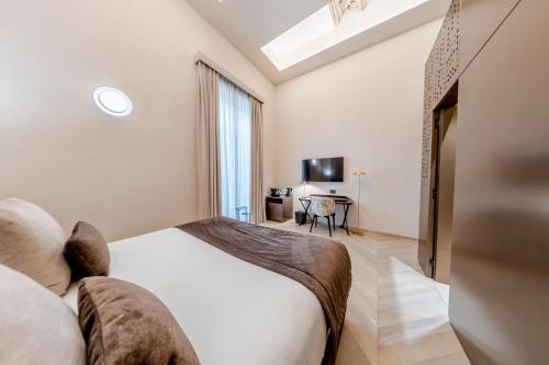 a bedroom with a large bed and a desk at Martius Private Suites Hotel in Rome