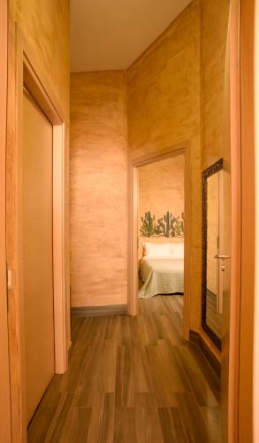 a hallway with a room with a bed and a mirror at Case Di Latomie in Castelvetrano Selinunte