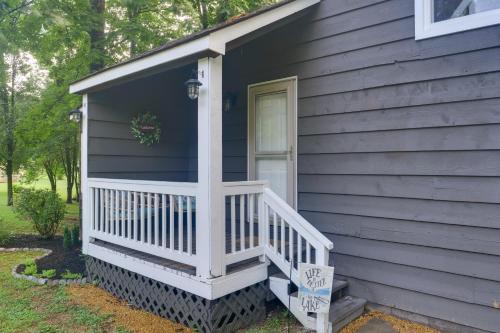 a blue house with a white porch and a door at Cozy Tennessee Cabin with Deck, Grill and Fire Pit! in Tullahoma
