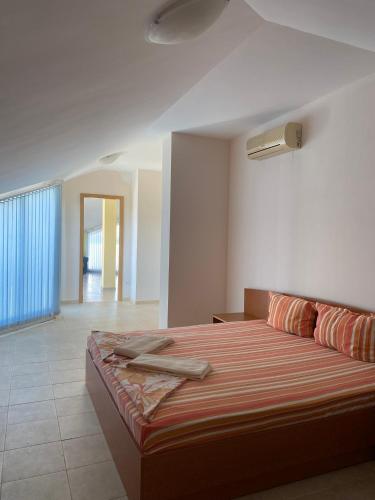a bedroom with a large bed in a room at Prostor Apartments in Obzor