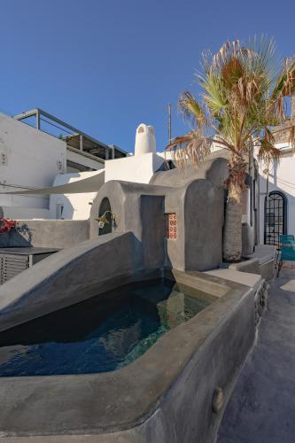 a swimming pool in the backyard of a house at Sophia Luxury Suites in Imerovigli