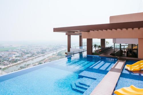 a swimming pool on the roof of a building at La Vela Hue Hotel in Hue