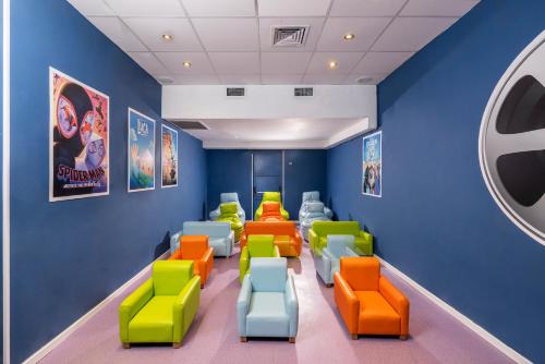 a waiting room with colorful chairs and posters at C Hotel Neve Ilan in Neve Ilan