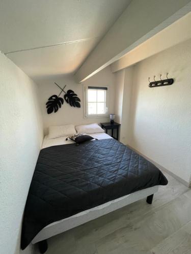 Ένα ή περισσότερα κρεβάτια σε δωμάτιο στο Appartement Duplex Climatisé Le Trident