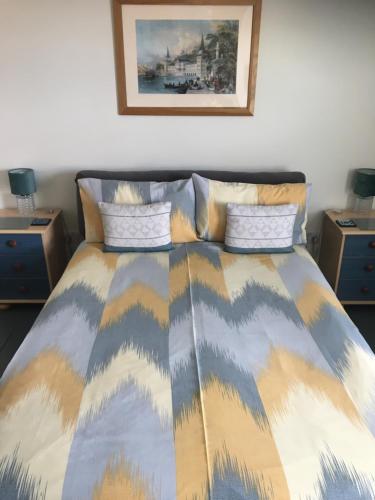 a bedroom with a bed with two night stands at The Corner House in Halesworth