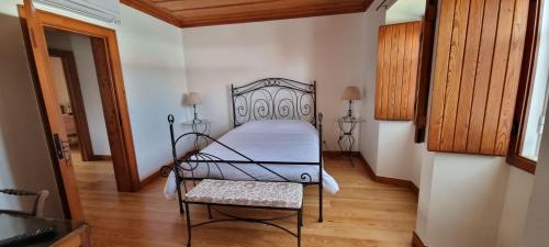 1 dormitorio con 1 cama y 1 silla en una habitación en Casa D'avó Mila - Ericeira, en Encarnação