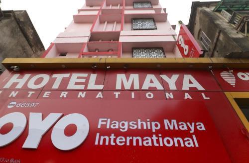 a sign on the side of a hotel maya international building at OYO Home Cozy Studio Collage Square Hotel Maya International Near St. Thomas's Church in Kolkata