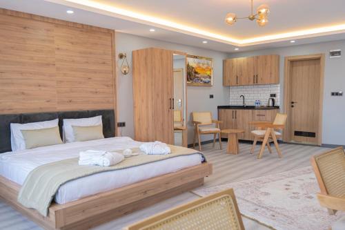 a bedroom with a large bed and a kitchen at Galata Greenland Hotel in Istanbul