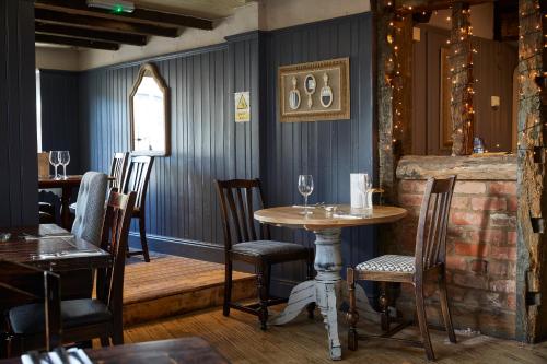 a restaurant with a table and chairs in a room at De Trafford Arms by Chef & Brewer Collection in Alderley Edge