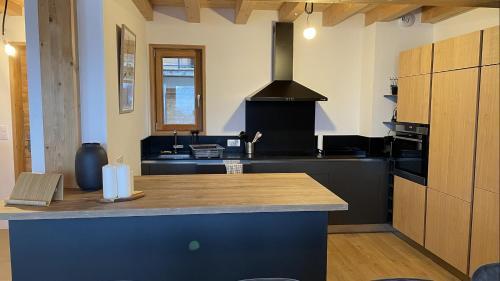 a kitchen with a black counter and a stove at Chalet La Mahure in La Toussuire