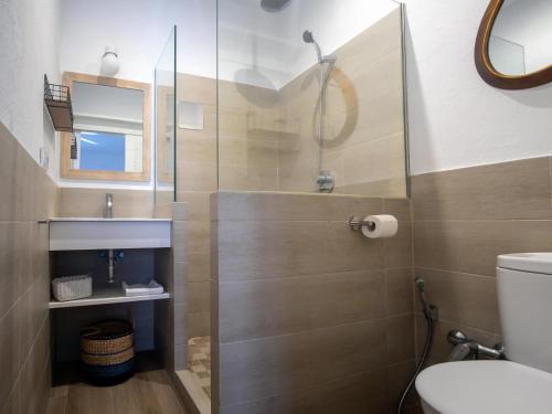 a bathroom with a toilet and a glass shower at REf 68 CASA MARGARITA in Zahara de los Atunes