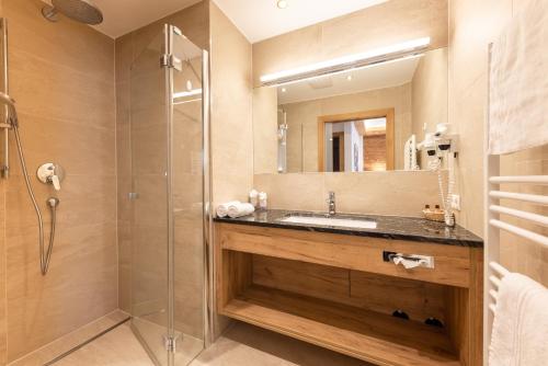 a bathroom with a sink and a shower at Aktiv & Vitalhotel Bergcristall in Neustift im Stubaital