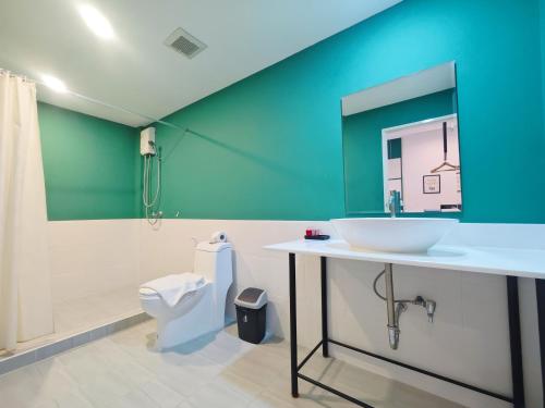 a bathroom with a sink and a toilet at Ostay Asoke Bangkok in Makkasan