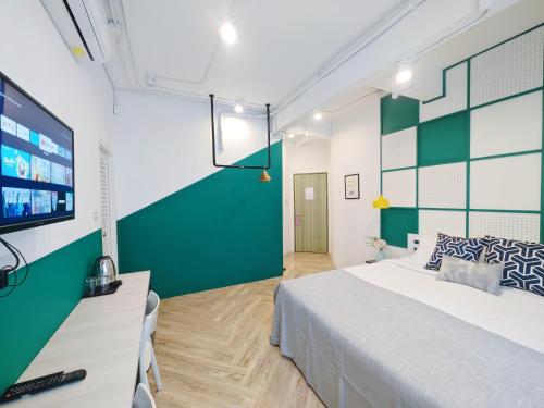 a bedroom with a bed and a flat screen tv at Ostay Asoke Bangkok in Makkasan
