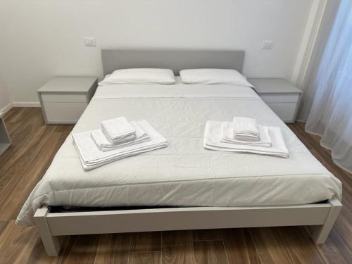 a bed with white towels on top of it at San Pellegrino Suites in San Pellegrino Terme