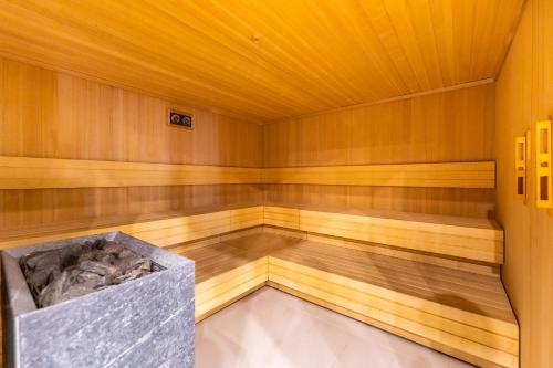 a sauna with wooden walls and a wooden floor at FARO Apartamenty Polanki Aqua SPA Deluxe 4 baseny w cenie, Pools inklusive in Kołobrzeg