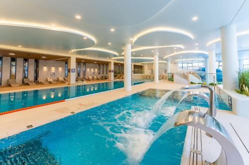 een zwembad in een hotel met een zwembad bij FARO Apartamenty Polanki Aqua Morskie Klimaty 4 baseny free parking in Kołobrzeg