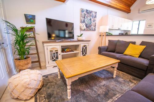 a living room with a couch and a table at Annie's Place - a downtown, mezzanine apartment in Albany