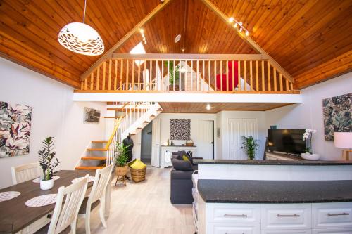 a kitchen and living room with wooden ceilings and a bar at Annie's Place - a downtown, mezzanine apartment in Albany