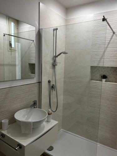 a bathroom with a glass shower and a sink at Insula Maris in Trani
