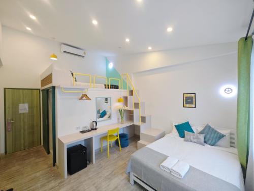 a bedroom with a bed and a desk in it at Ostay Asoke Bangkok in Makkasan