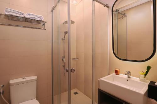 a bathroom with a shower and a toilet and a sink at Citadines Gatot Subroto Jakarta in Jakarta