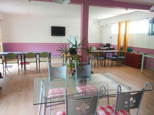 une pièce avec une table, des chaises et une télévision dans l'établissement Gites et Chambres La colo du gave, à Auterrive