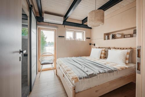 a bedroom with a large bed and a window at HOUSEBOAT FRED Prague in Prague