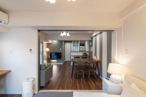 a living room and dining room with a kitchen and a living room at H2H Dotonbori in Osaka