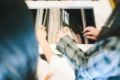 two children are playing with books on a shelf at Hotel She, Kyoto in Kyoto