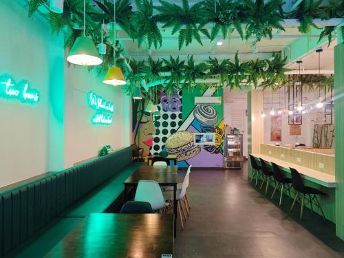 a dining room with tables and chairs in a restaurant at Ostay Asoke Bangkok in Makkasan