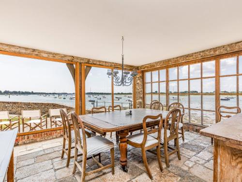 a dining room with a table and chairs at Pass the Keys Historic Waterfront Home in Bosham in Bosham