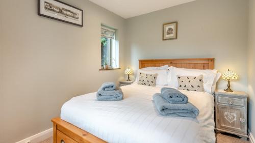 a bedroom with a bed with towels on it at Hawkfield in Baslow