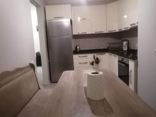 a kitchen with a table and a stainless steel refrigerator at Vacation Home Nukri in Gonio