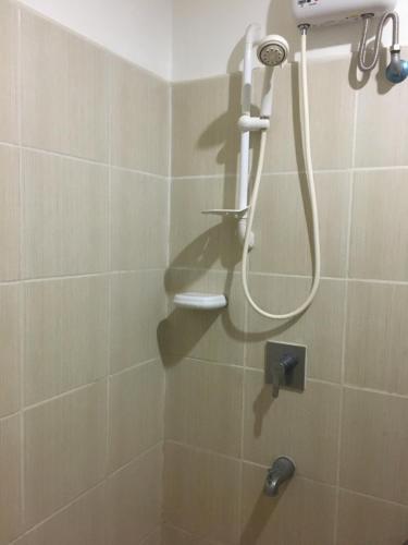 a bathroom with a shower with a shower head at Simple & Cozy 1 Bedroom US Embassy, Roxas Blvd, Ermita, Manila in Manila