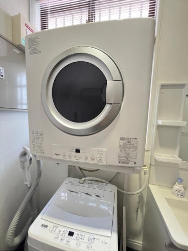 a hospital room with a microwave and a machine at VERY in Naha