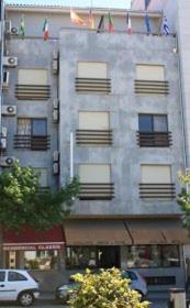 an apartment building with a car parked in front of it at Hotel Classis in Bragança