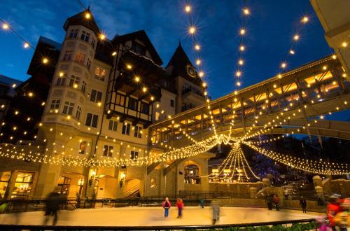 a building with christmas lights and a skating rink at Lift House Lodge, Pet Friendly Studio Condo in Vail