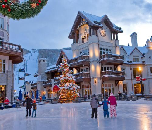a christmas tree in front of a ski lodge at Lift House Lodge, Pet Friendly, Premium Studio Condo in Vail