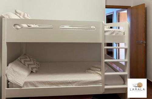 a white bunk bed in a small room at Larala 03 - Nuevo apartamento frente al mar en el Arenal en Jávea in Jávea