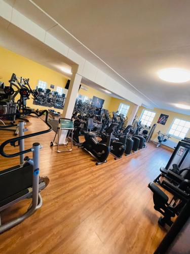 a gym with a bunch of treadmills and exercise bikes at Tauriņkrasti in Bērzciems