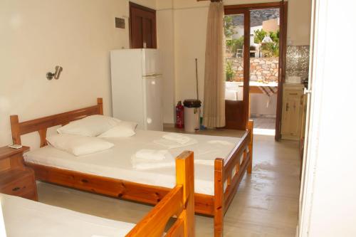 a bedroom with a bed and a refrigerator at Aristidis in Galissas