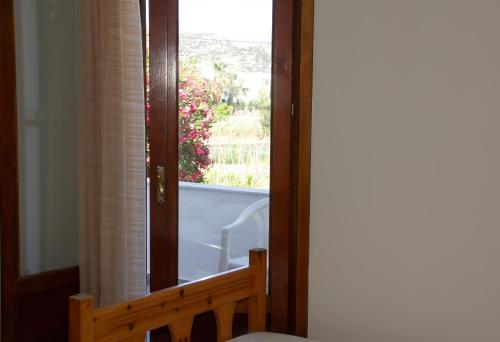 a bathroom with a glass door with a window at Aristidis in Galissas