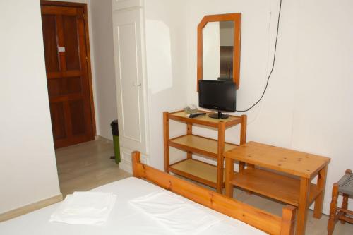 a room with a mirror and a table and a tv at Aristidis in Galissas