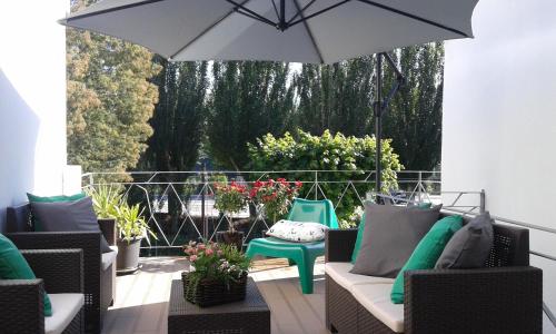 a patio with chairs and an umbrella at Vistadouro 2 in Peso da Régua