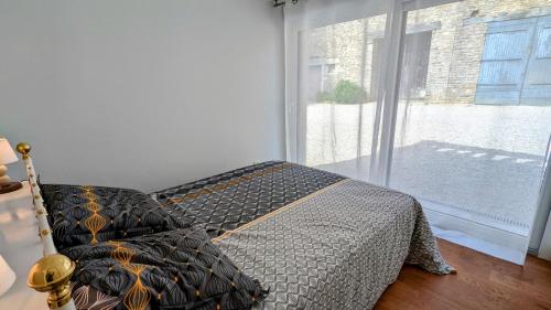 a bedroom with a bed and a large window at Le Cocon et le panorama des Hautes-Côtes in Fussey