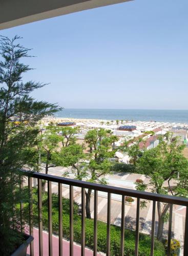 a balcony with a view of the beach at Hotel Mon Cheri in Riccione
