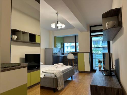 two pictures of a room with a bed and a kitchen at Studios Copou IRO Parhon in Iaşi
