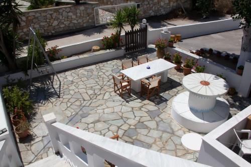 a patio with a table and chairs on a stone floor at Aristidis in Galissas